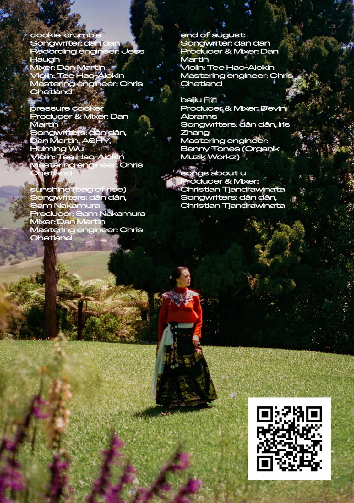 back cover: full song credits for the EP over a photo of dān dān on a sunlit lawn, with a QR code